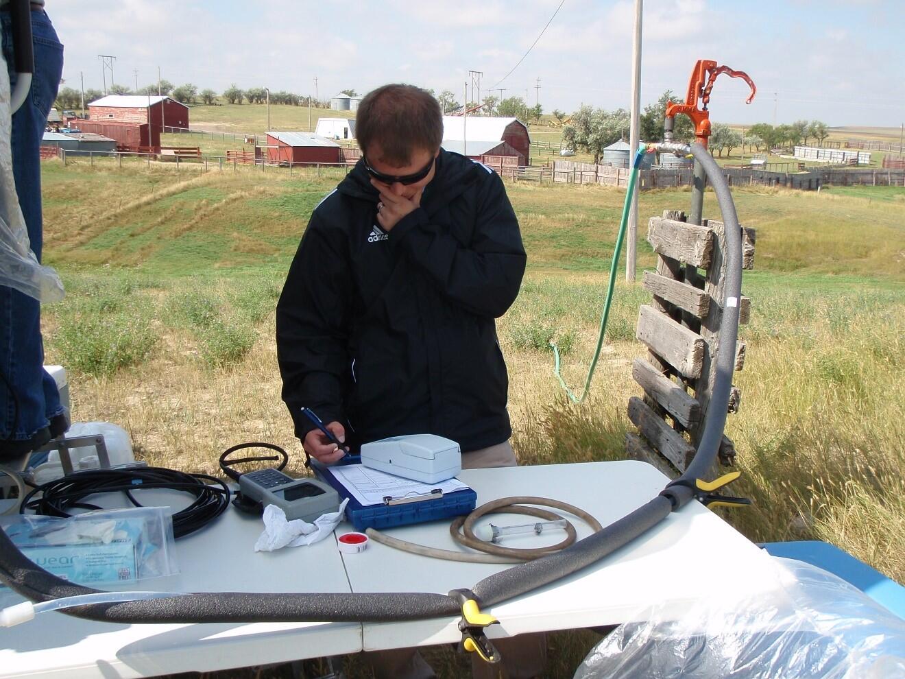Man taking notes during groundwater sampling