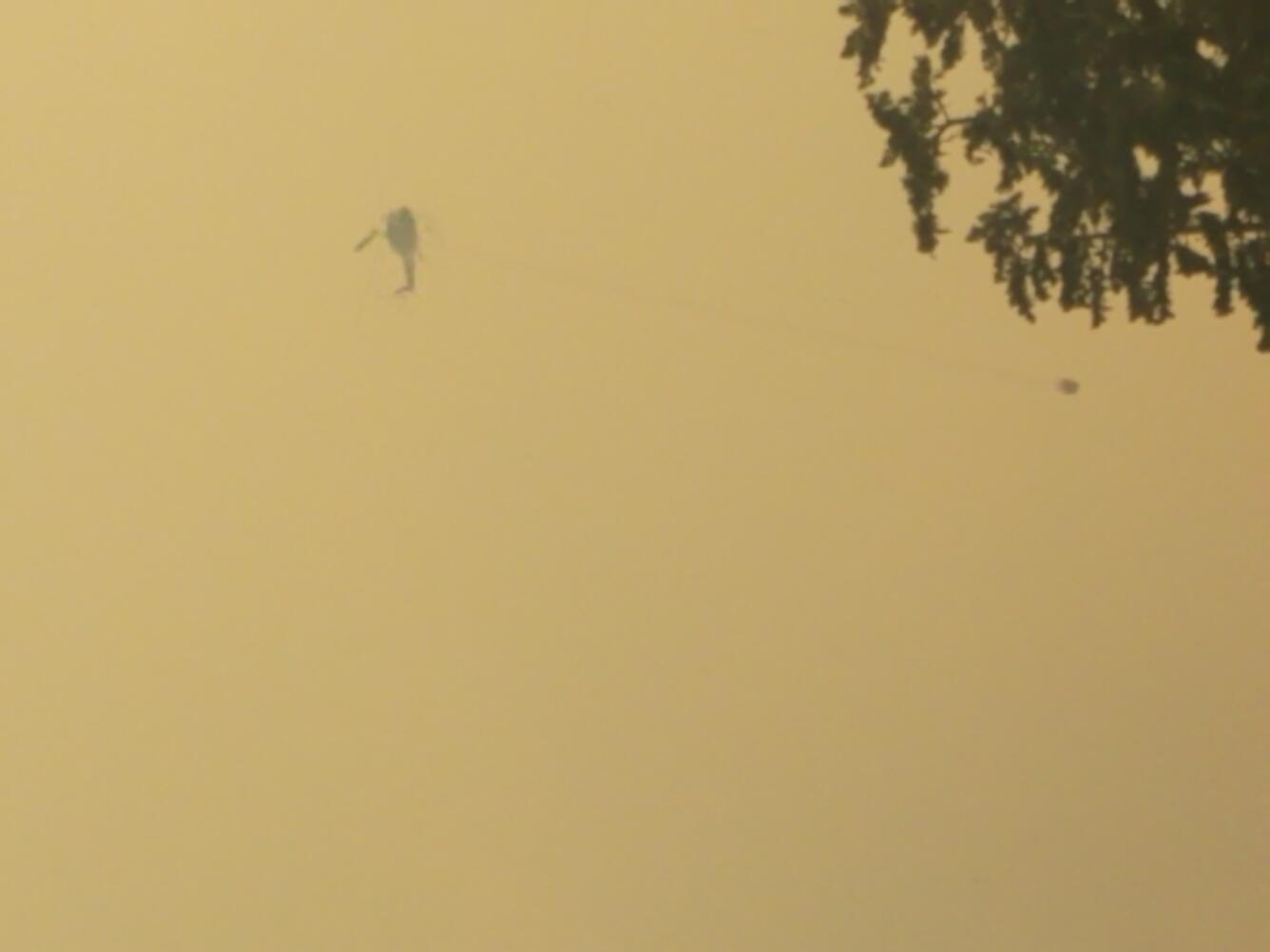 color photo of helicopter over fire