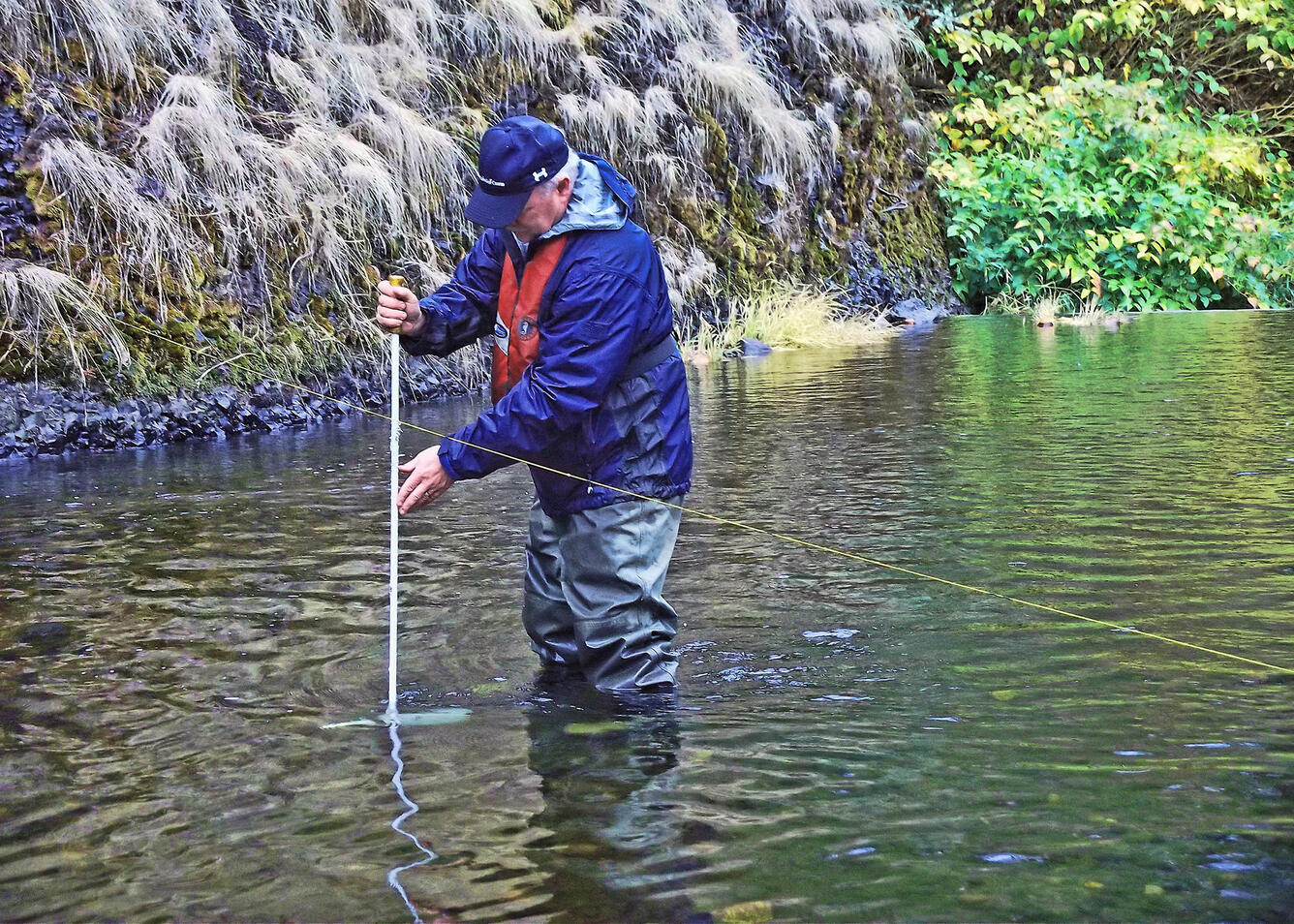 Hydrologic technician collecting a sediment sample