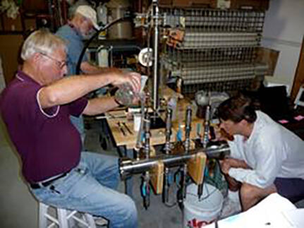 Photograph of USGS personnel leak testing the Instrumented Pressure Testing Chamber