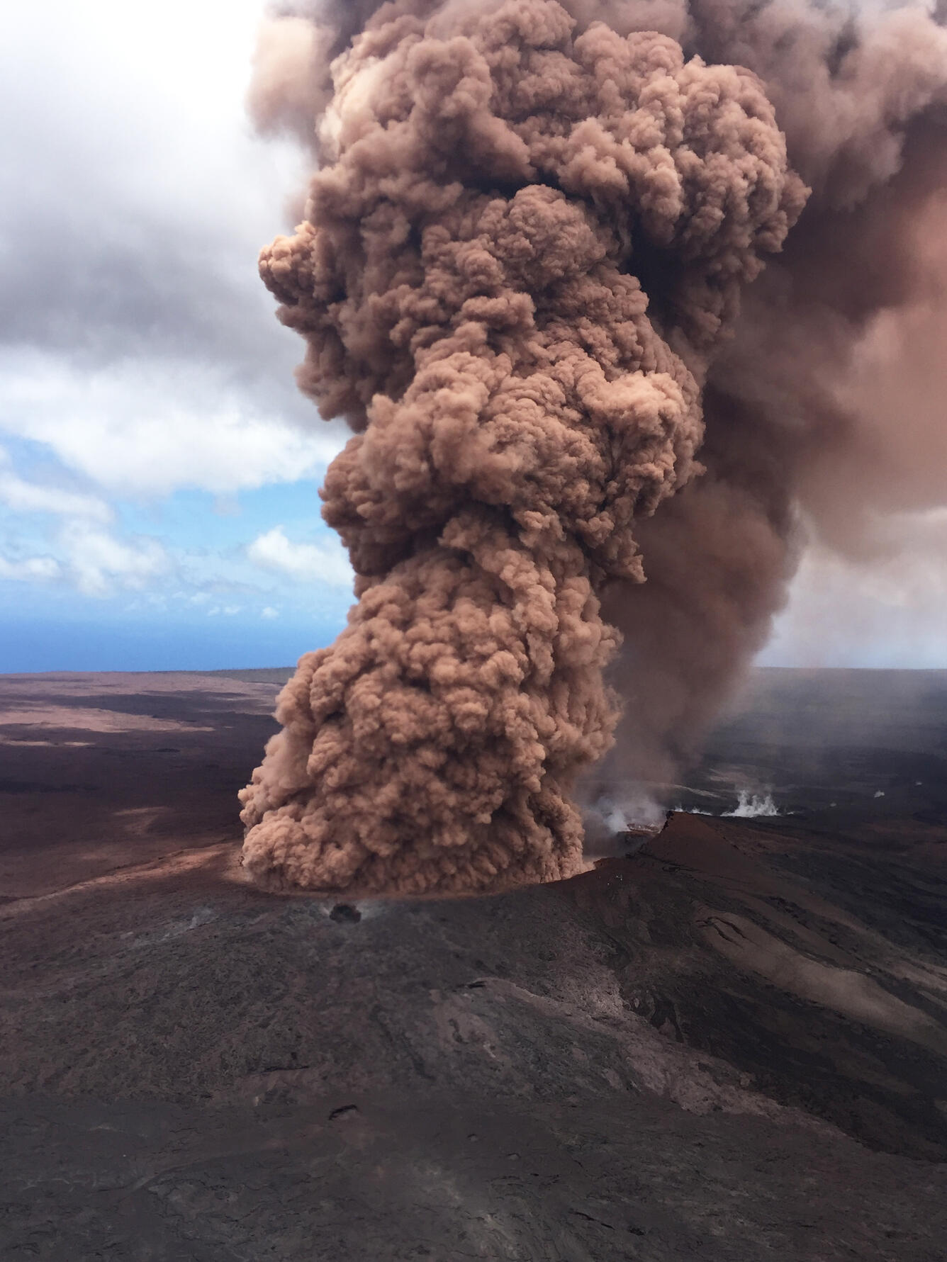 plume of reddish-brown ash skyward