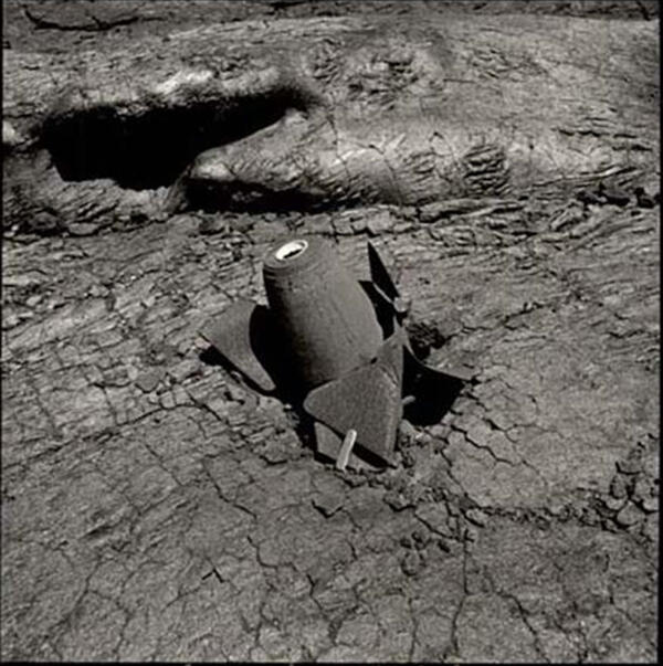 Black and white photograph of pointer bomb in lava flow