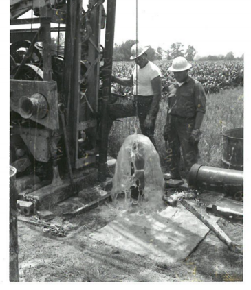 Flowing well next to corn field