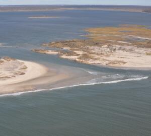 channel flowing through sandy beach