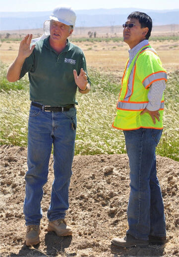 CAWSC hydrologist John Izbicki and T.J. Kim, Chief Engineer for the LA County Department of Public Works, discuss a recharge-pon