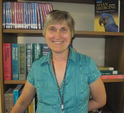 Katherine Wesenberg in front of a bookshelf.