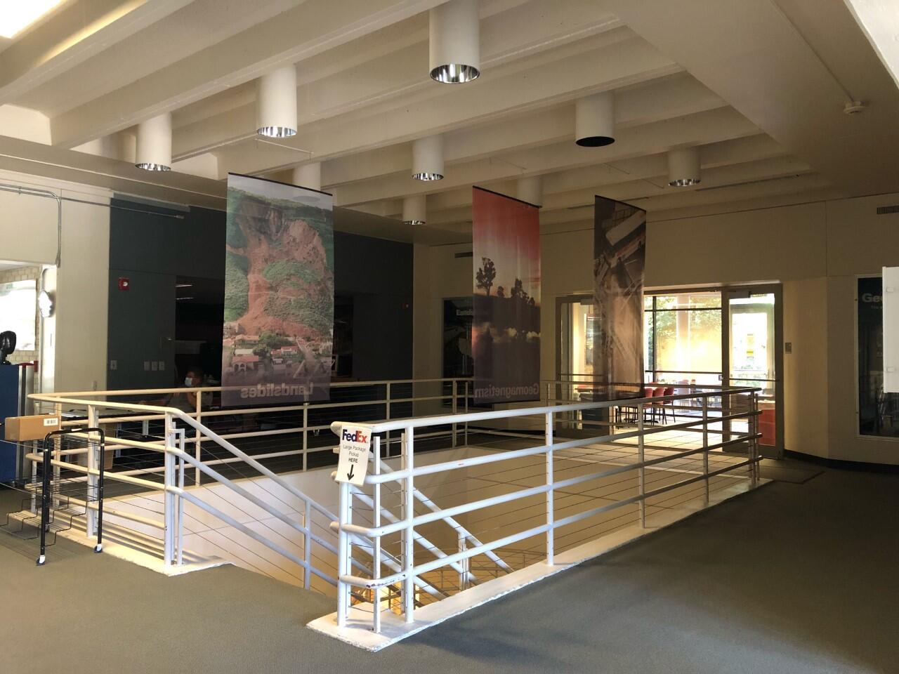 lobby with glass doors in back and stairwell going down near front