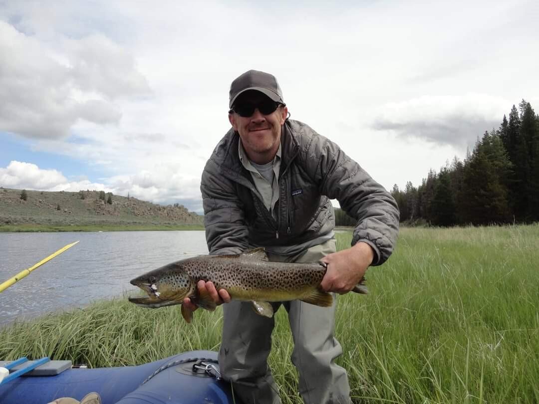 employee holding a fish