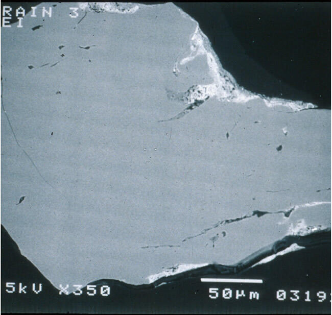Electron photomicrograph of a cross section of a quartz grain from sediments on Cape Cod, MA, shows coatings 