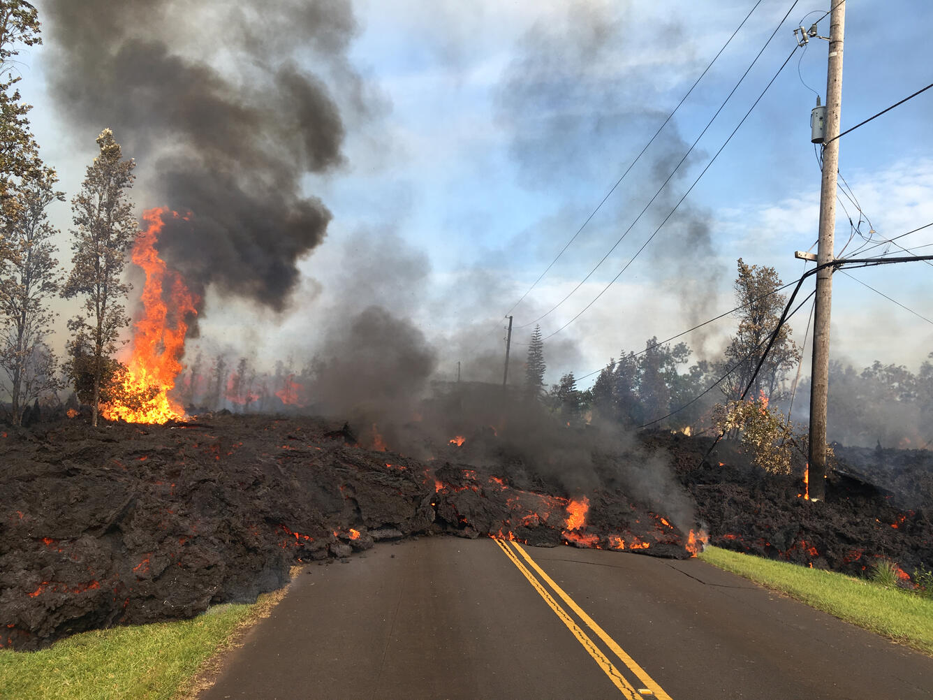 Lava from a fissure slowly advanced to the northeast on Hookapu Street in Leilani Estates subdivision on Kīlauea Volcano's lower