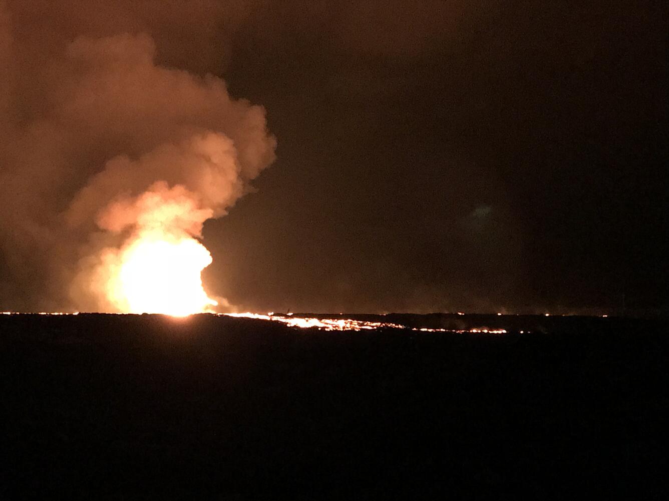 Lava fountaining at night time.