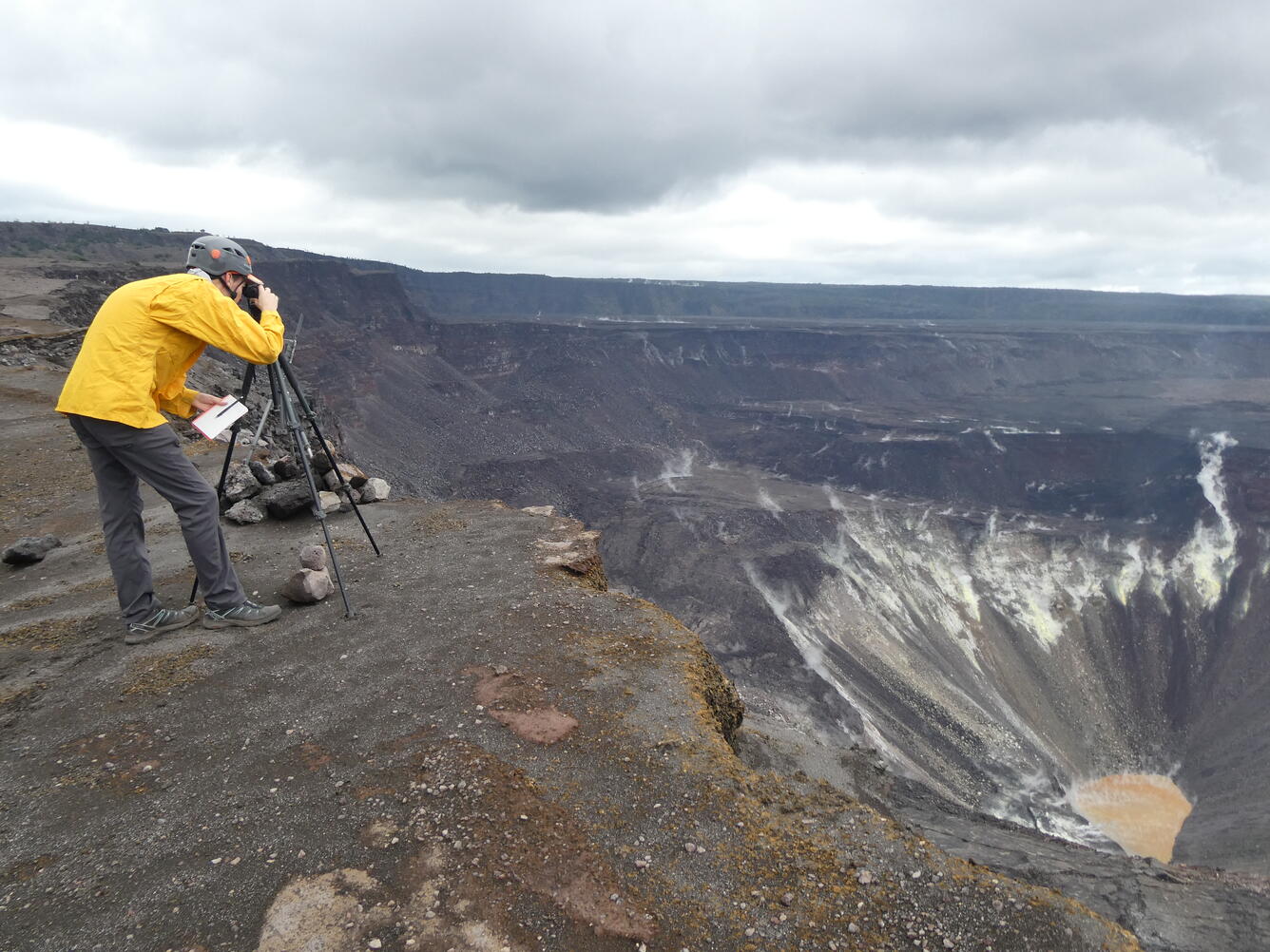 A scientists observes a volcano crater