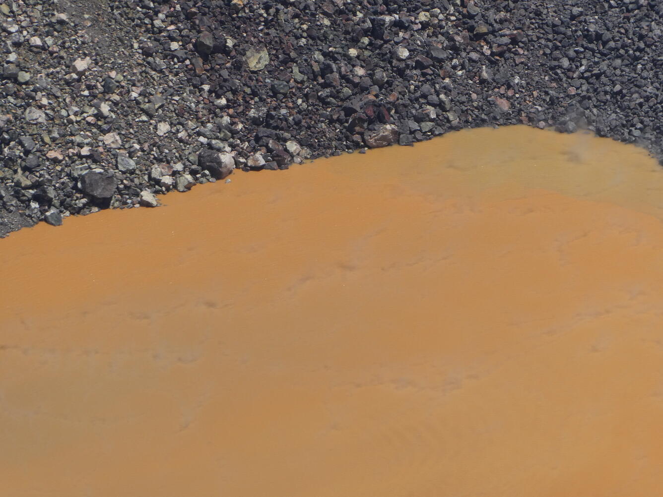 Color photograph of volcanic crater lake margin