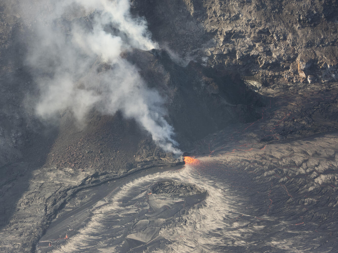 Color photograph of volcanic vent and lava lake