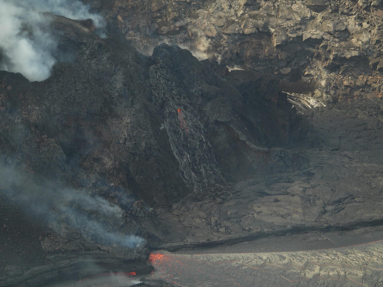 Color photograph of volcanic vent and lava lake