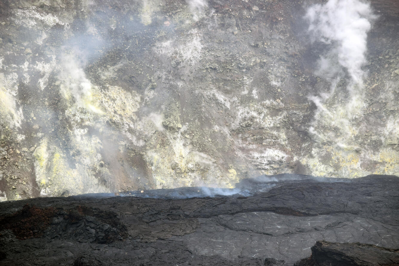 Color photograph of lava lake and crater wall