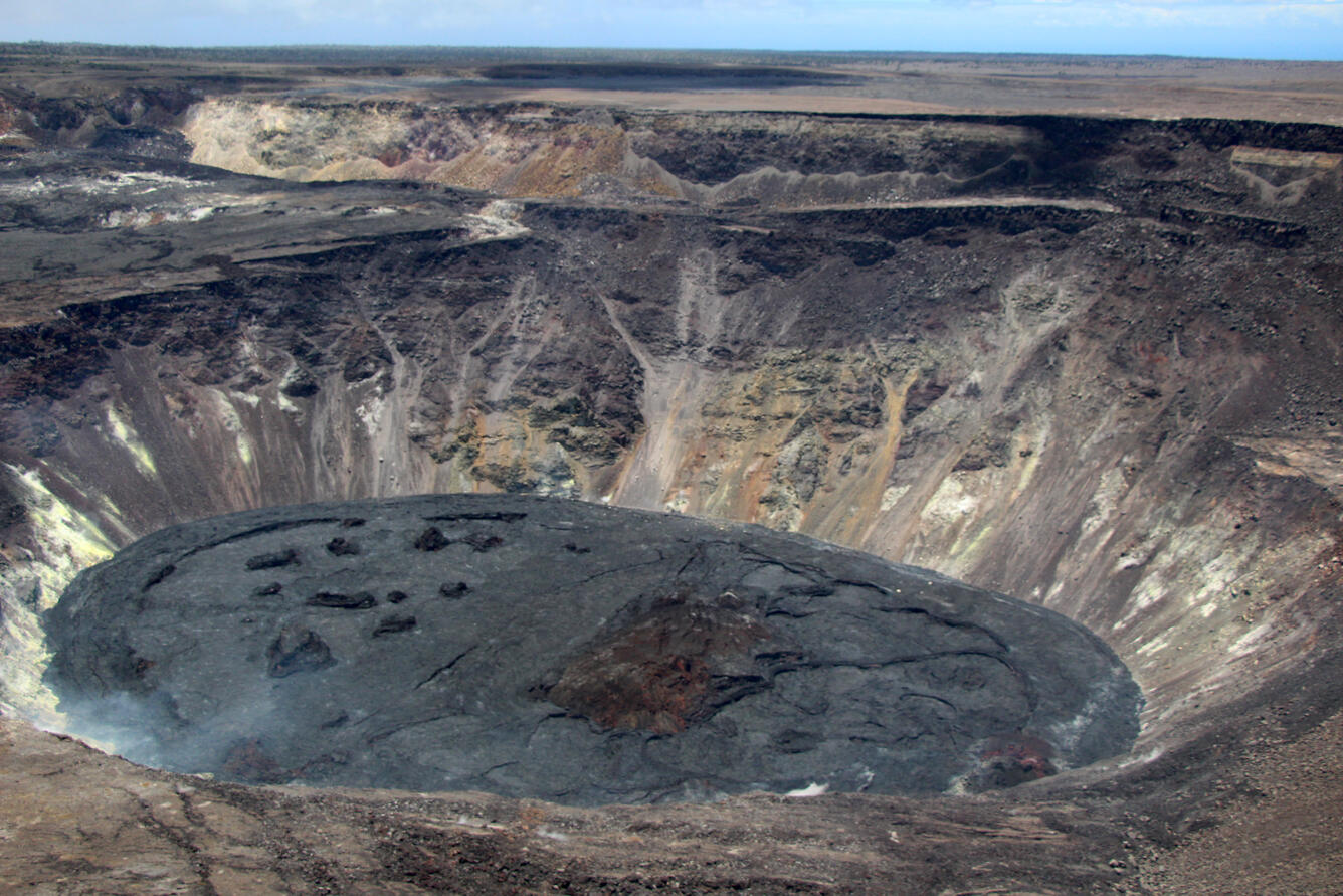 A view of the crusted over lava lake within Halema‘uma‘u at Kīlauea summit