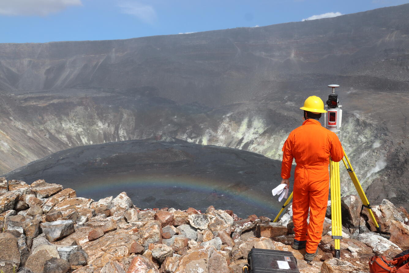 An HVO geologist conducts a routine high-precision survey of the inactive lava lake in Halema‘uma‘u, at the summit of Kīlauea