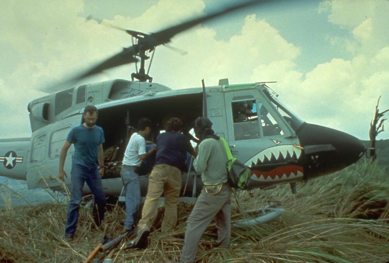 scientists loading gear into helicopter