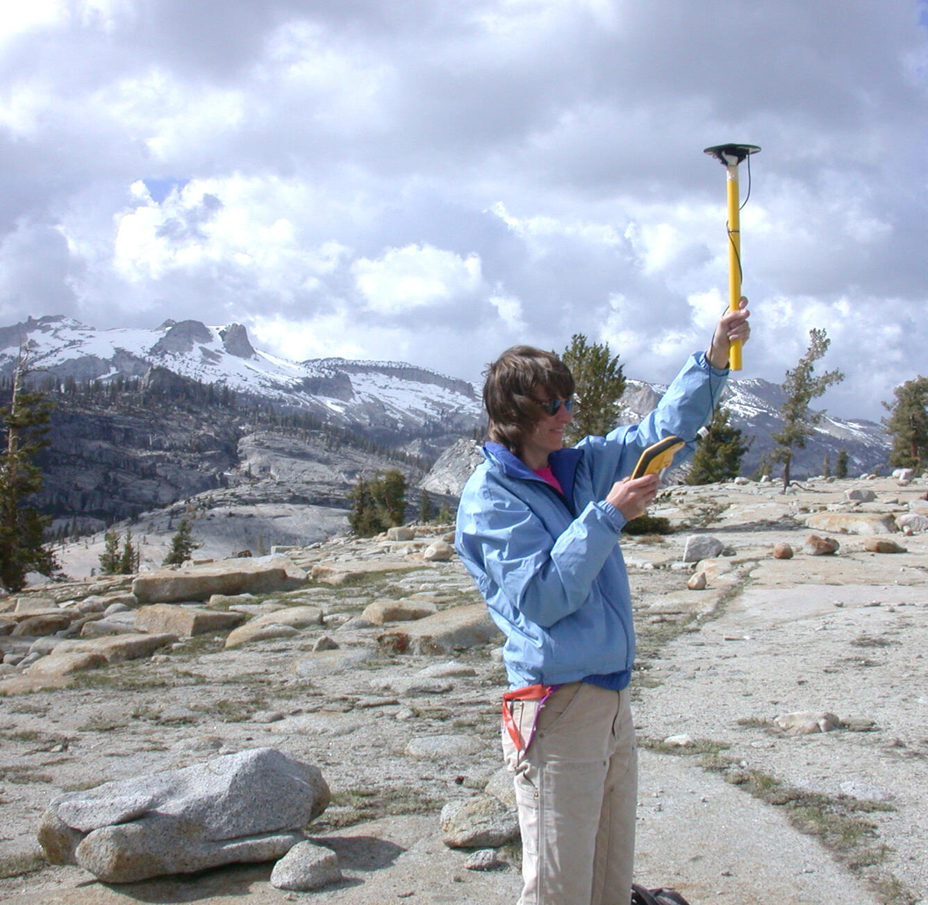 A photo of a USGS scientist collecting GPS data before an incoming storm.