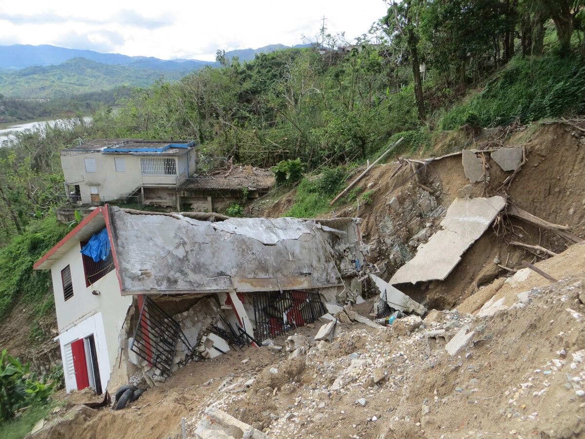 house on slope that is slipping down and falling apart