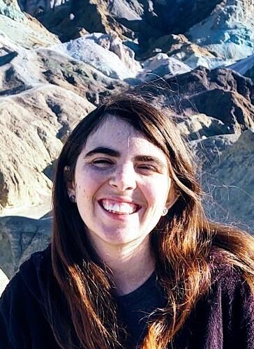 Woman with long hair smiles at camera