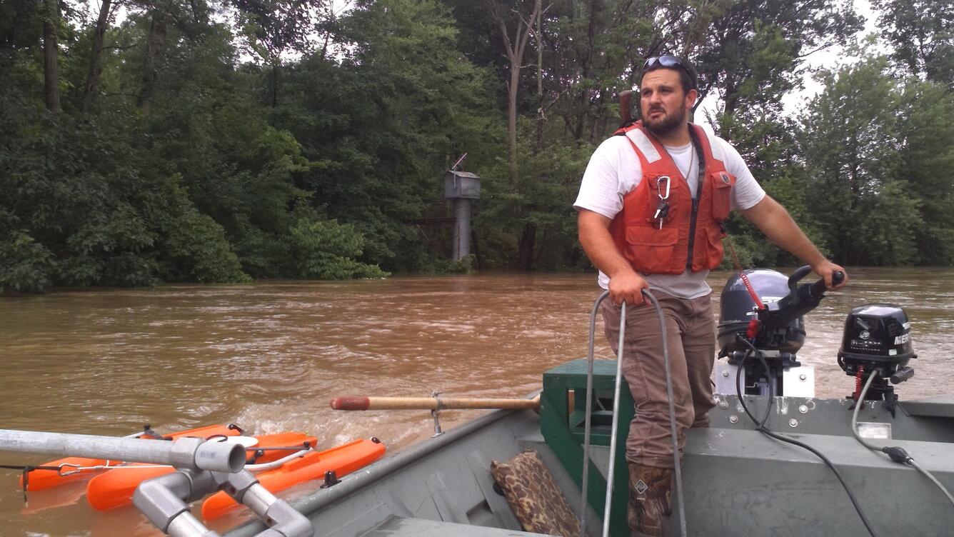 Photo of Hydrologic Technician Cameron Ensor, piloting a flood boat near Hershey, PA.