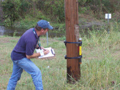 Deployment of a temporary hurricane storm-surge sensor. Deployment includes a metal pipe containing storm surge sensor strapped 