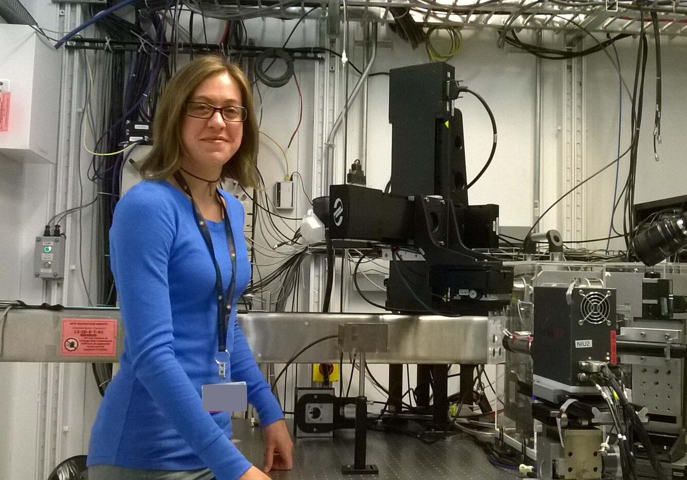 Sheryl Singerling, a geologist, stands next to a synchrotron X-ray fluorescence microprobe