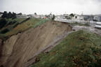 Landslide next to a road with some houses