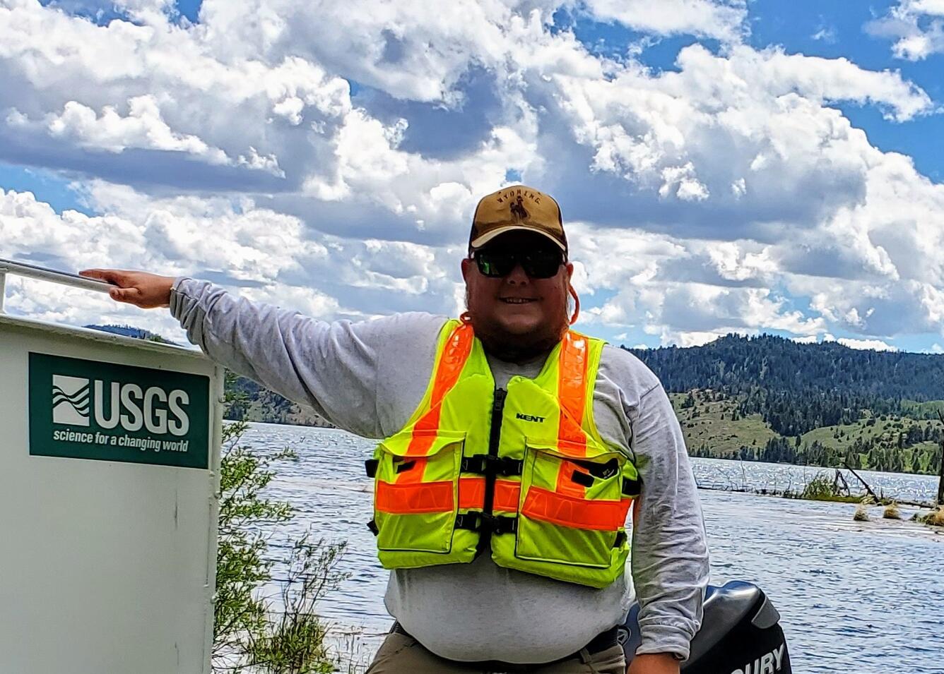 employee standing in front of a river