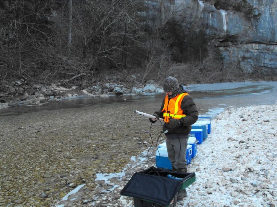 USGS Scientist collecting water samples in a stream