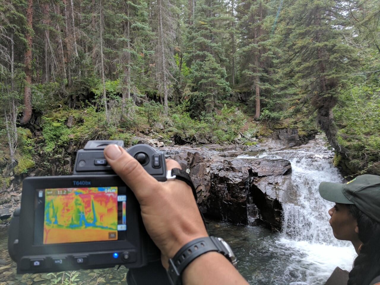 Scientist taking picture of groundwater discharge with infrared camera
