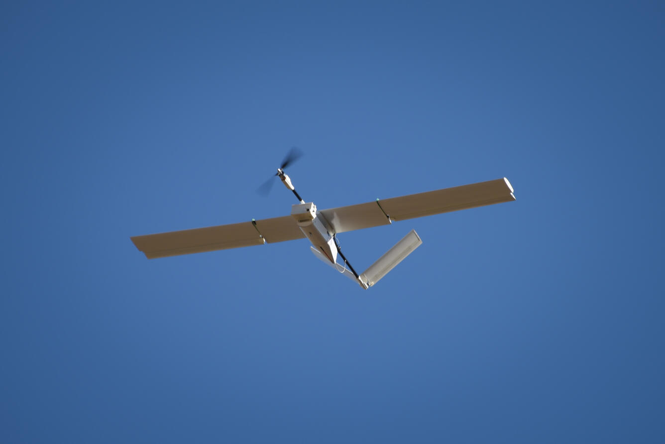 An unmanned aircraft or drone flying.