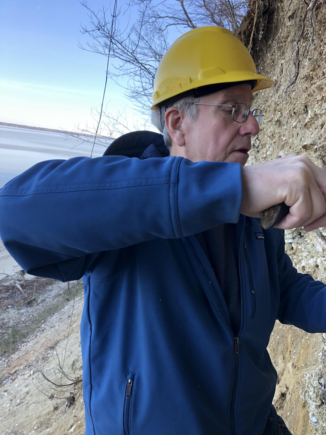 A scientist takes samples from an outcrop in SE VA