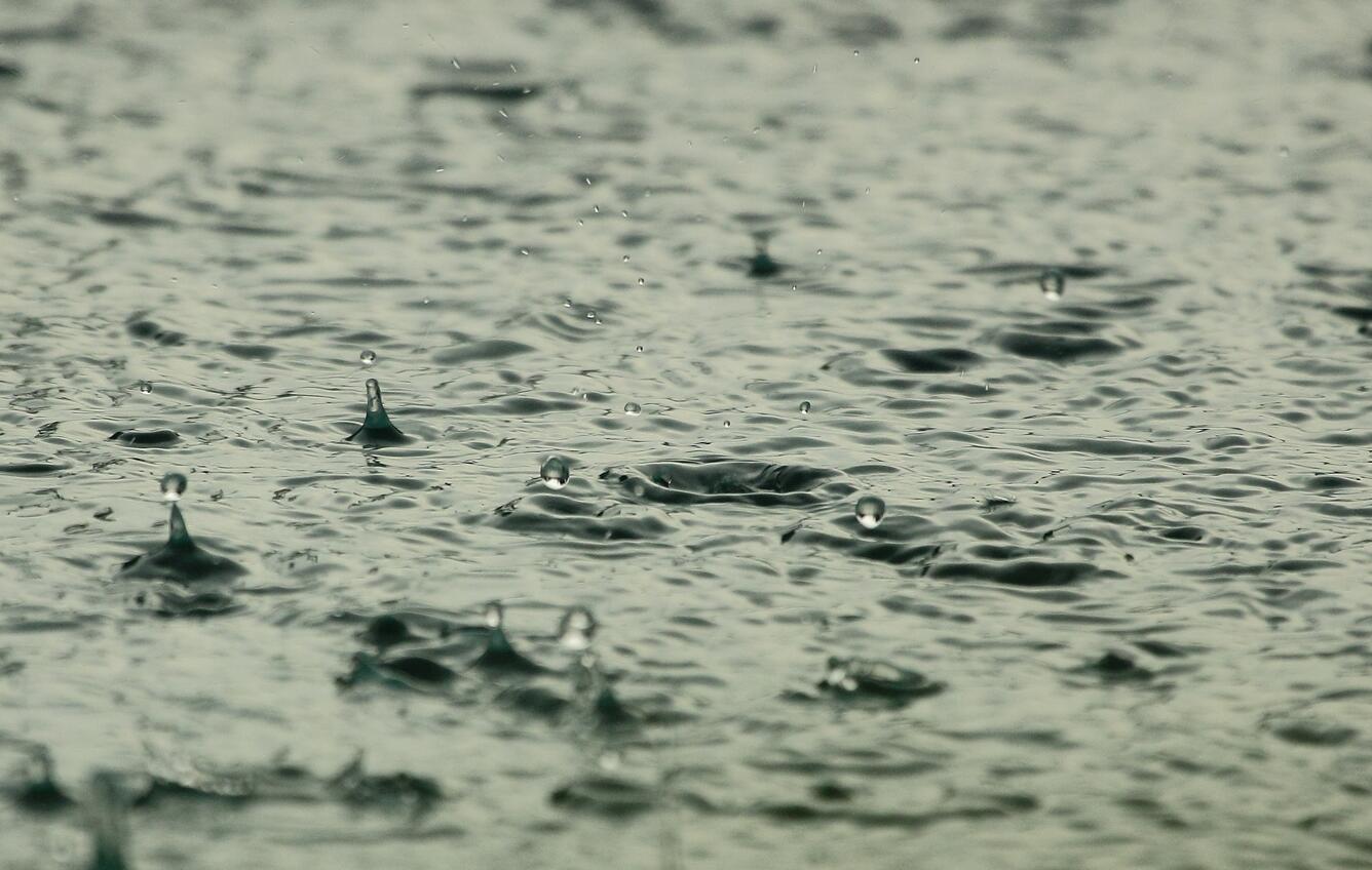 Rain droplets on a watery surface