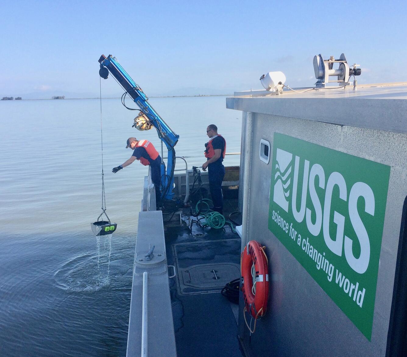 USGS scientists taking water quality measurements aboard the R/V Peterson.