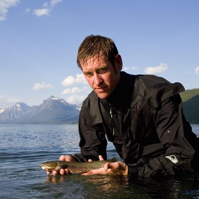 USGS scientist Clint Muhlfeld holds a native westslope cutthroat trout in his hands