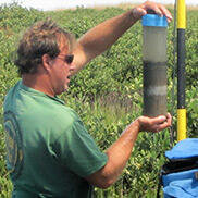 Scientist holds a sediment core.