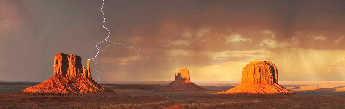 Desert landscape showing lightning and rainstorm