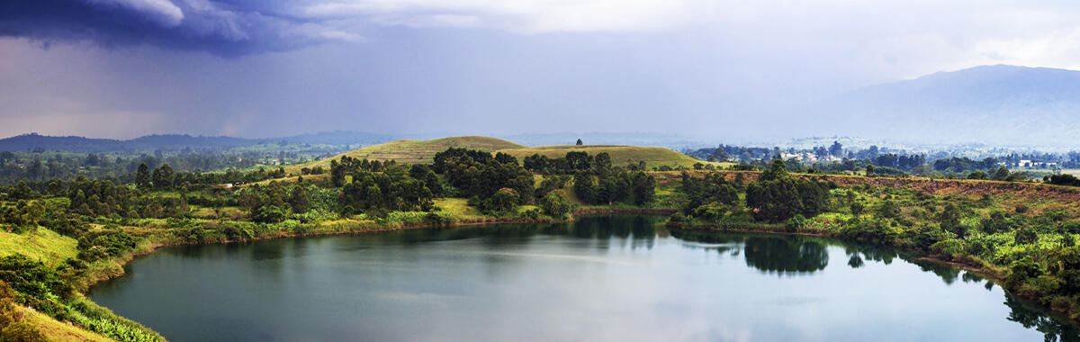 A lake in a landscape with rain falling
