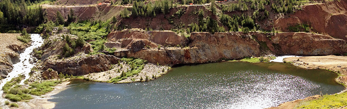 An old mine showing a lake alongside the digging area