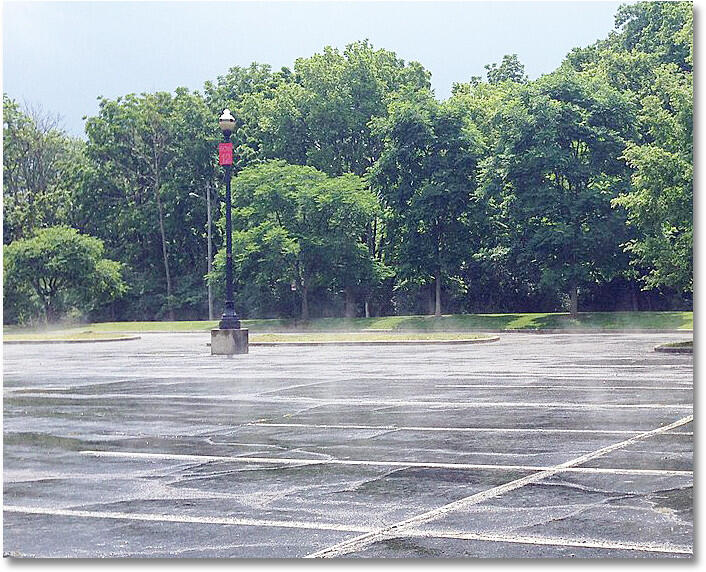 After a summer thunderstorm, steam rises from rainfall heated by the pavement.