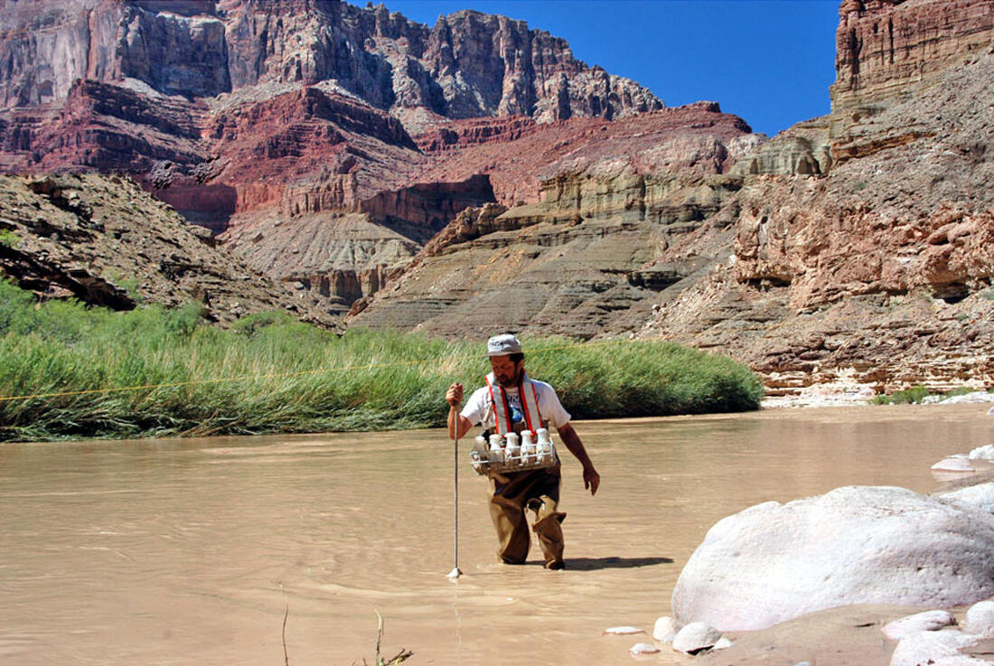 USGS hydrographer collecting a suspended-sediment water sample from the highly turbid Little Colorado River in the Grand Canyon.