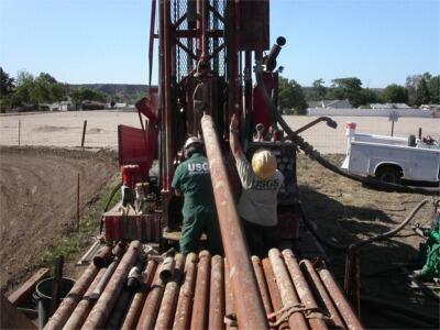 pipe being lifted by hydraulics of drill rig