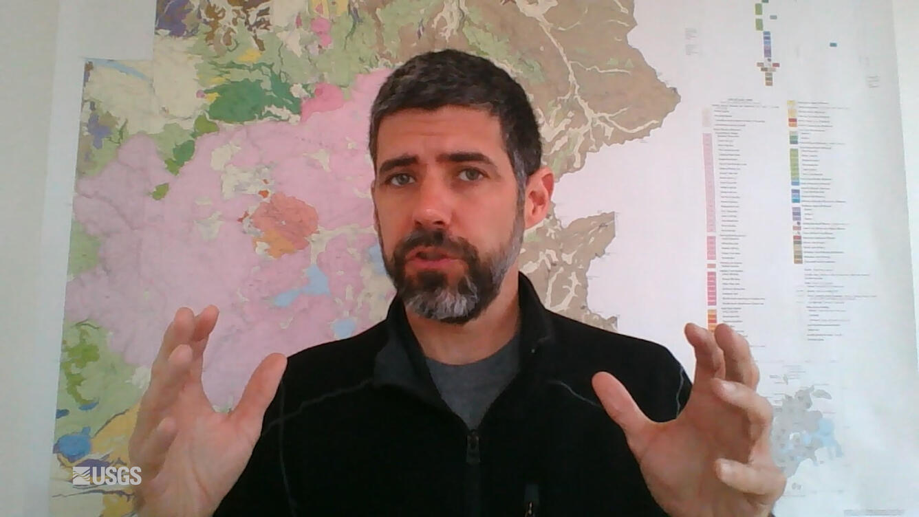 Man sitting in front of a map