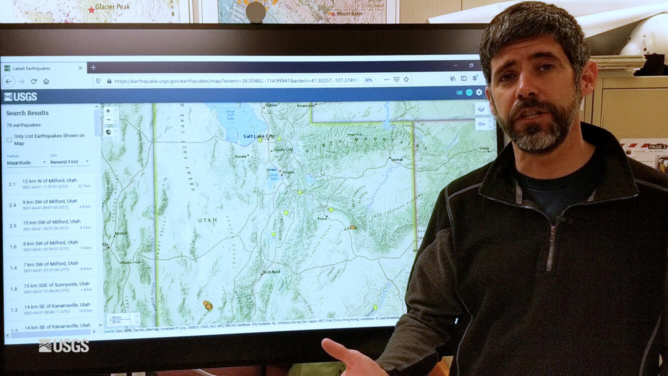 Man talking about a map of Yellowstone on a TV screen