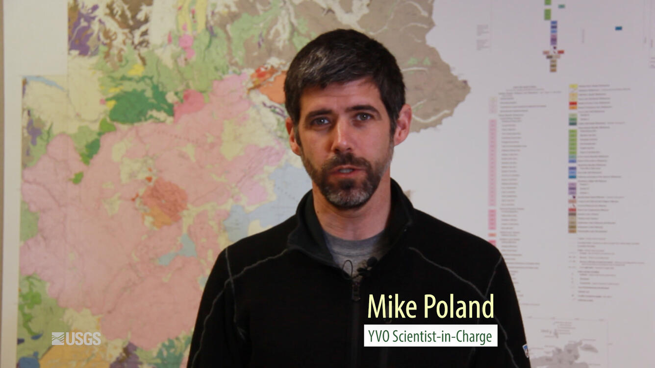 Man sitting in front of a map