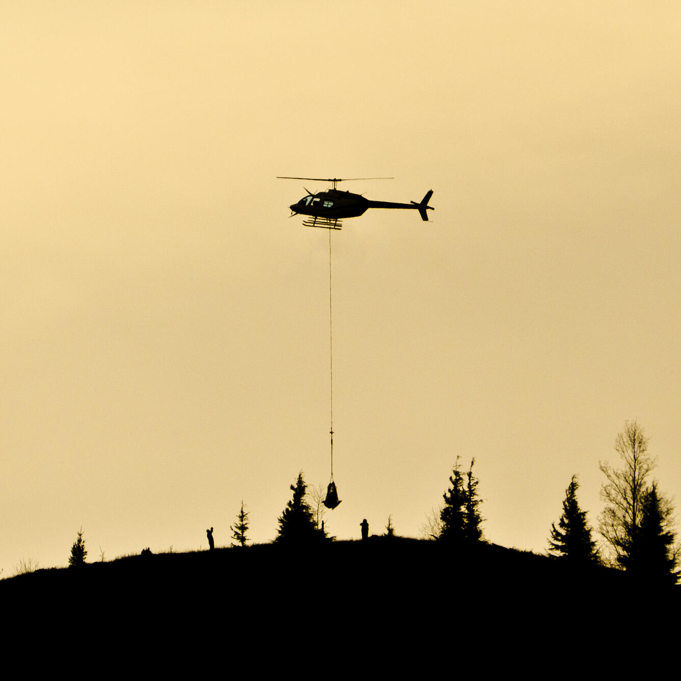 Helicopter dropping off monitoring equipment at Mount St. Helens, W...