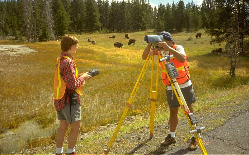 A volunteer and a US Geological Survey employee conduct a leveling ...